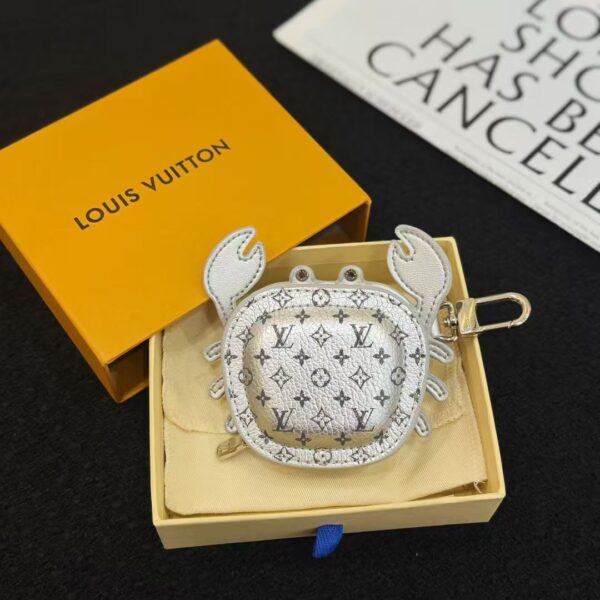 Close-up of crab shape leather keychain pouch showing detailed stitching and textured metallic surface.