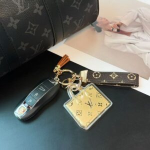 Luxury leather car keychain with gold charm and monogram strap